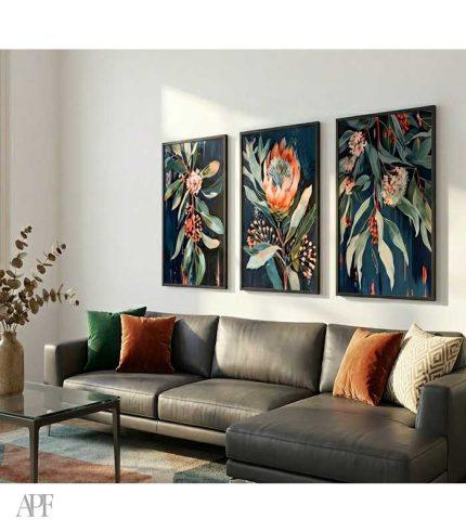modern living room with dark teal botanical triptych above gray sofa