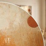 close-up showing warm terracotta gradients and textured botanical shapes